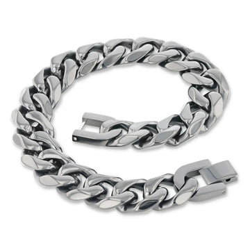 Close-up of a polished stainless steel 14mm Cuban link chain bracelet with box clasp, partially unfastened