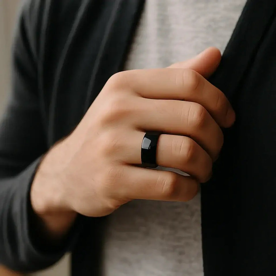 Black domed tungsten wedding band worn on a person’s hand, showcasing width and high-polish shine