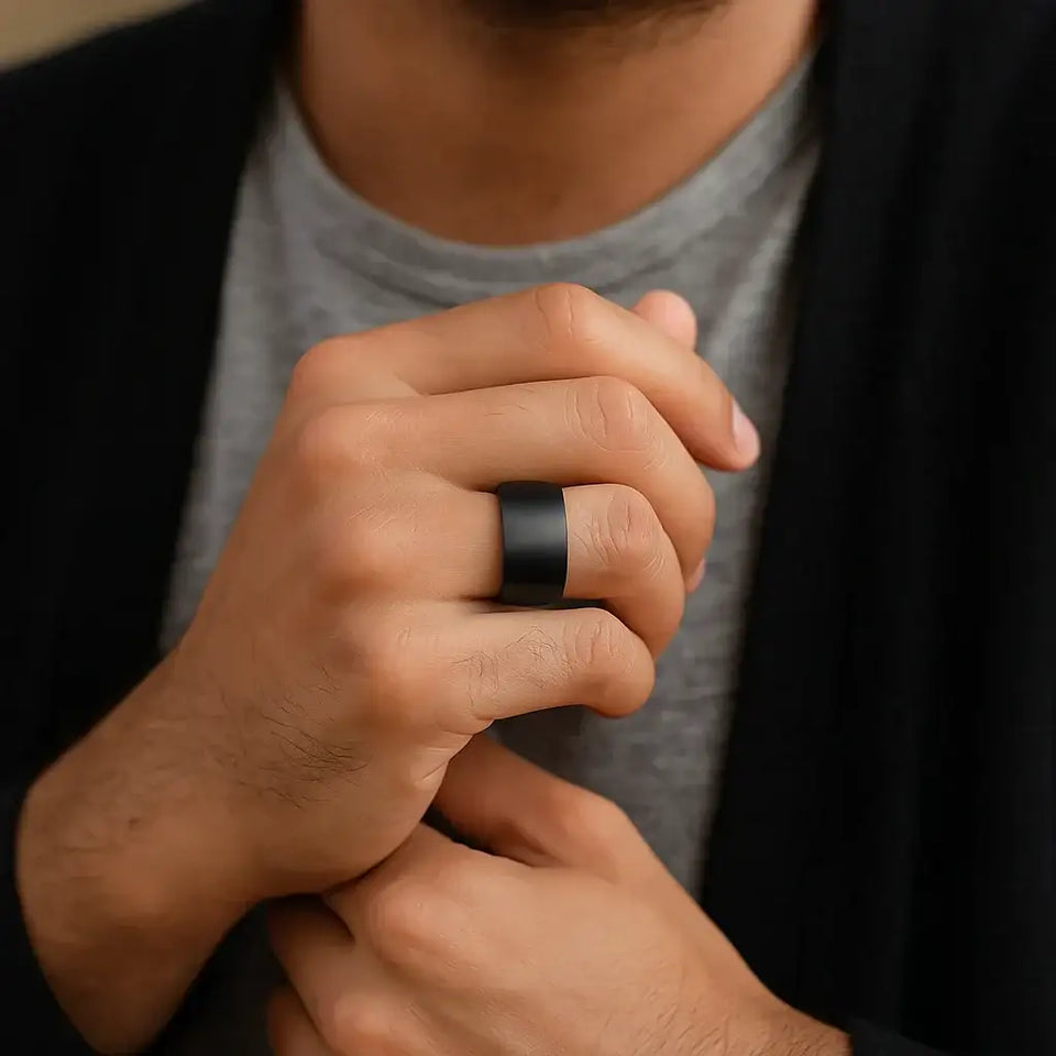 Lifestyle photo of a person wearing a black brushed tungsten carbide ring, domed profile