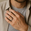 Lifestyle image: person wearing a domed polished tungsten carbide wedding band on ring finger