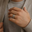Lifestyle photo of a person wearing a polished white tungsten flat wedding band