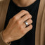 Lifestyle image of a person wearing the 8mm white tungsten carbide ring with a brushed center and polished beveled edges.