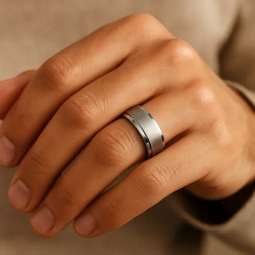 Ring-on-hand view showing the 8mm satin-center tungsten carbide band with polished step edges