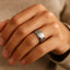 Ring-on-hand view showing the 8mm satin-center tungsten carbide band with polished step edges