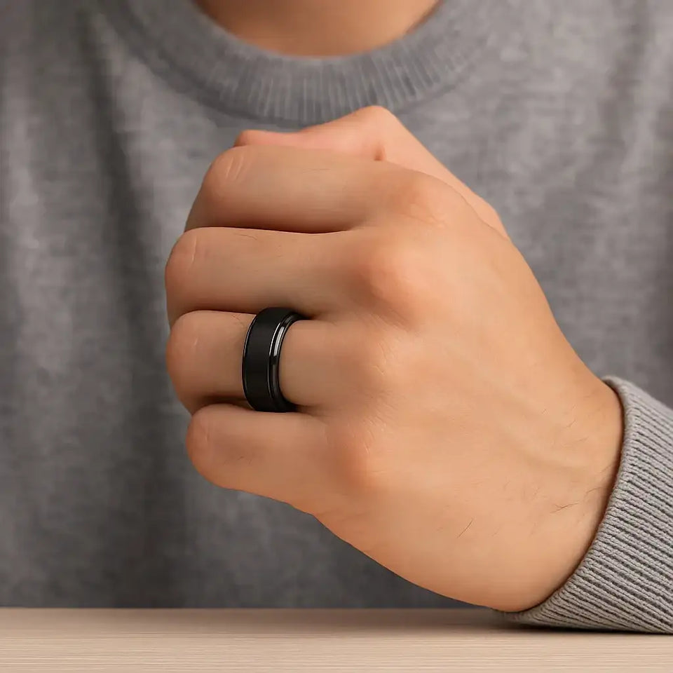 Angled view of the REVOLVE black tungsten spinner ring highlighting the brushed spinner and glossy domed edges