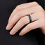 Lifestyle close-up of a black diamond-faceted tungsten ring worn on a hand