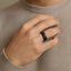 Top-down view of the 8mm black hammered tungsten carbide ring showing the textured outer edge and smooth inner circle