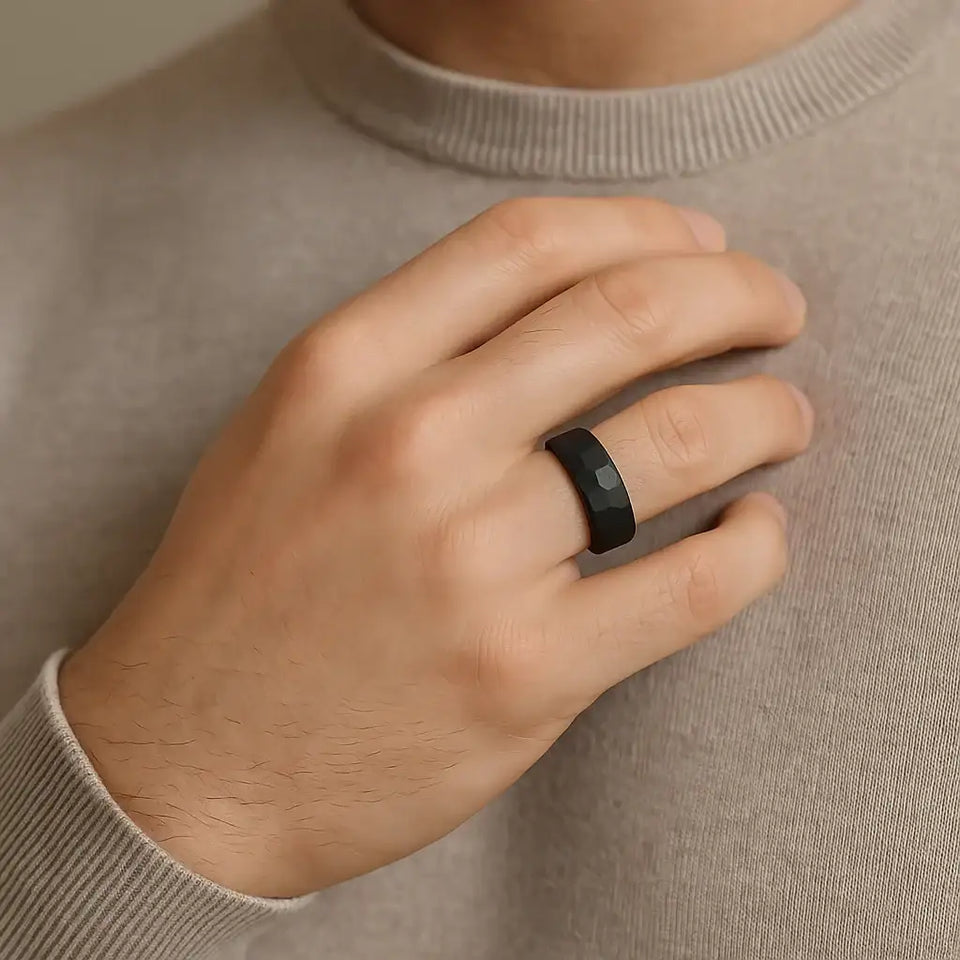 Top-down view of the 8mm black hammered tungsten carbide ring showing the textured outer edge and smooth inner circle
