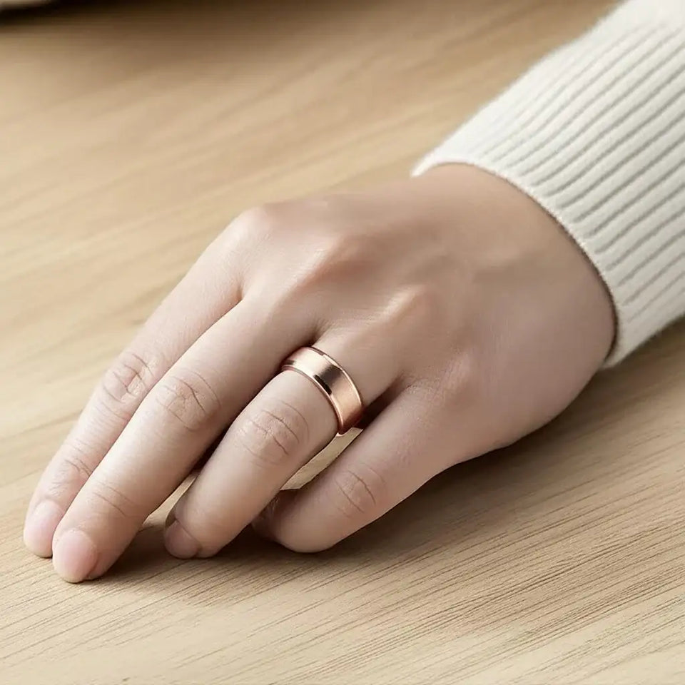 Rose gold-plated tungsten carbide wedding band with satin center and polished edges, flat front view