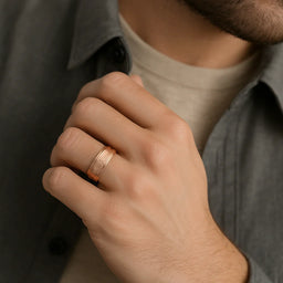 Rose tungsten carbide hammered center step-edge ring worn on a man's hand for scale