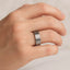 Close-up of the brushed titanium flat wedding band worn on a hand