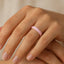 Lifestyle view of the 4mm pink ceramic domed ring worn on a hand, showing its glossy finish.