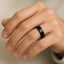 Model wearing a flat polished black ceramic wedding band on ring finger