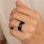 Lifestyle render of black titanium beveled-edge ring with brushed center, 8mm width