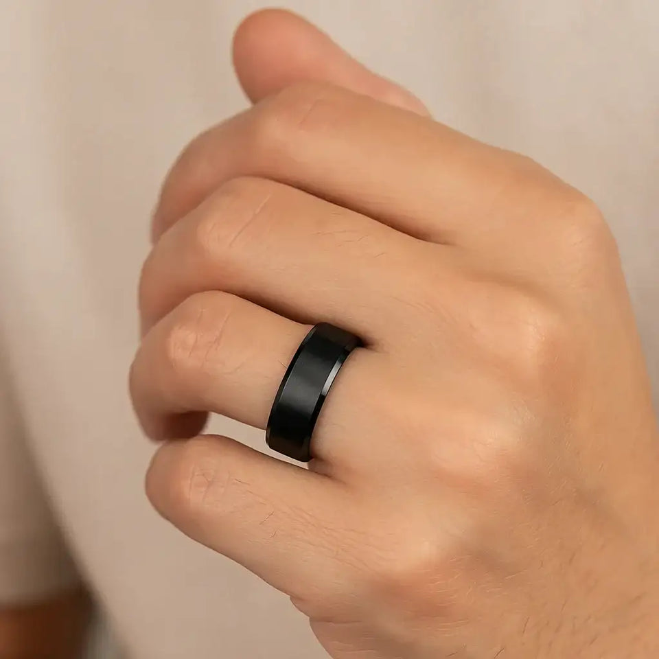 Lifestyle render of black titanium beveled-edge ring with brushed center, 8mm width