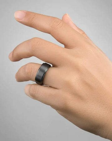 Black titanium ring worn on a hand, showing the 8mm width and polished step edges.