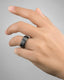 Black titanium ring worn on a hand, showing the 8mm width and polished step edges.