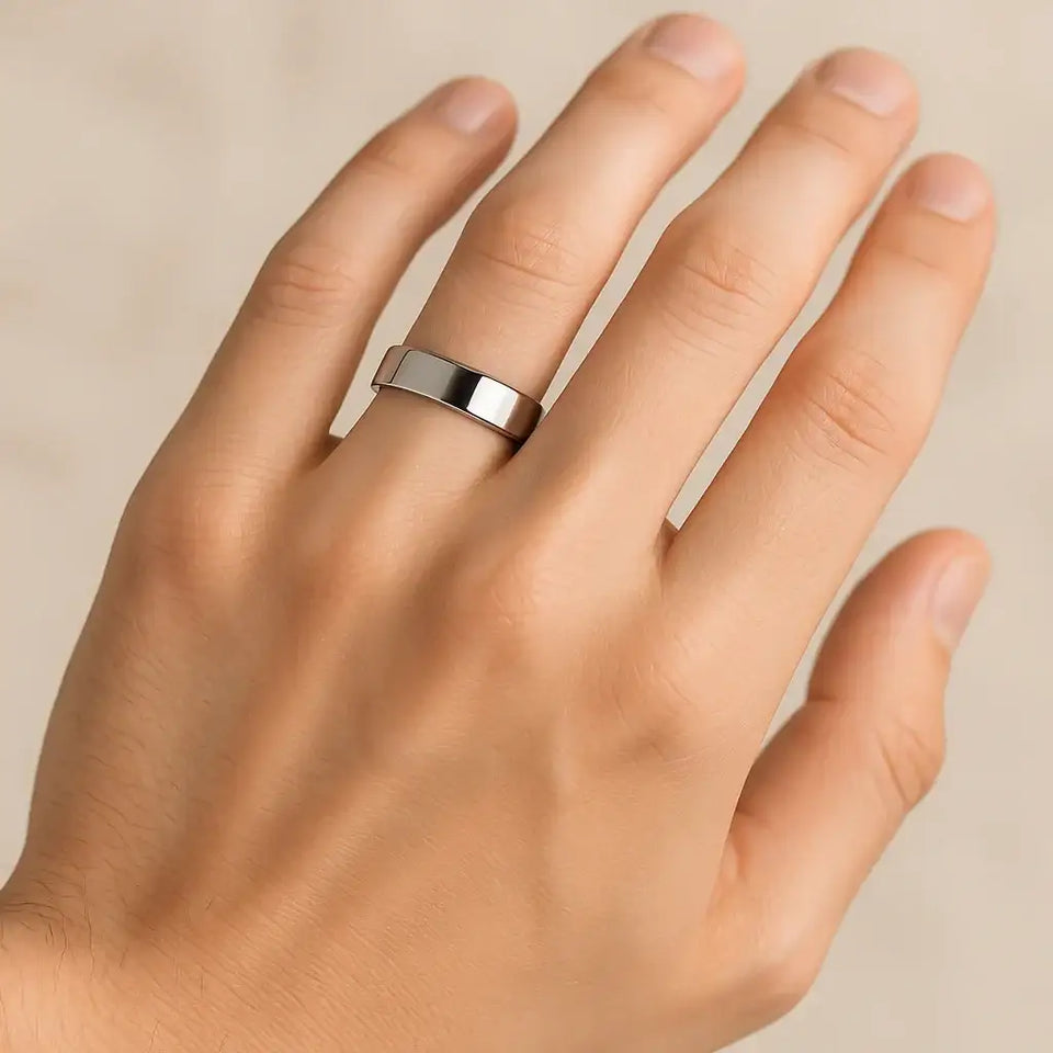 Polished flat cobalt chrome ring worn on a hand, showcasing mirror finish