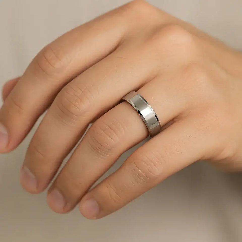 Polished cobalt chrome beveled-edge ring worn on a hand, showing slim 4–6mm width and comfort-fit shine