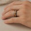 Lifestyle shot of the 8mm tungsten carbide ring with gold flakes inlay worn on a hand