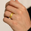 Gold-plated titanium ring shown on a hand, demonstrating fit and 8mm width