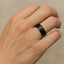 YORKSHIRE black ceramic wedding band on a hand, highlighting the brushed finish and beveled edges.