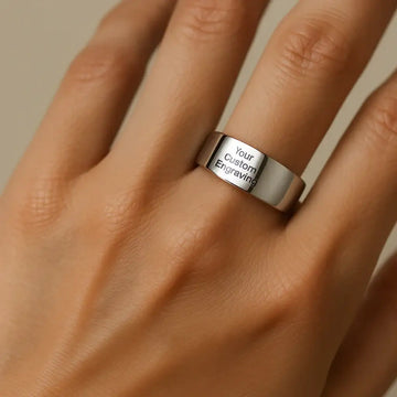 Polished tungsten carbide ring with custom engraving text shown worn on a hand