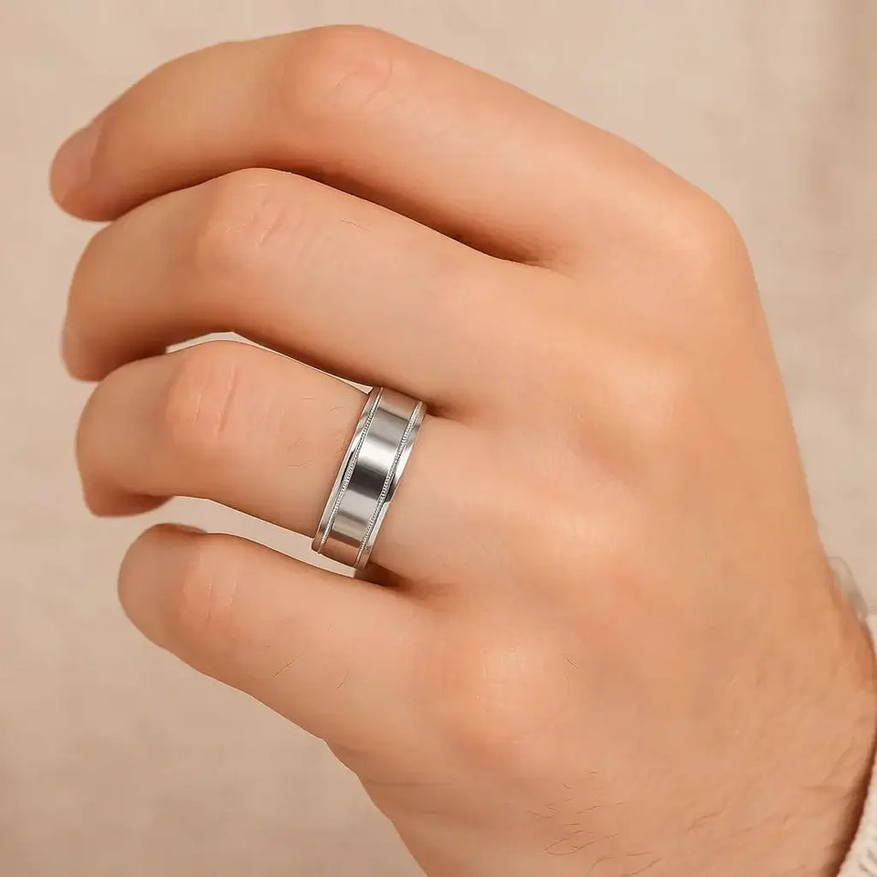 ArtCarved Covenant 14k white gold wedding band with polished flat center and milgrain edges shown on a hand