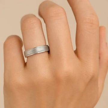 14k white gold wedding band with milgrain edges shown on a hand