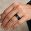 Domed black titanium and sterling silver ring on hand, showing comfort-fit and beaded interior edge