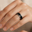TRISTAN black titanium wedding band with polished step edges shown on hand