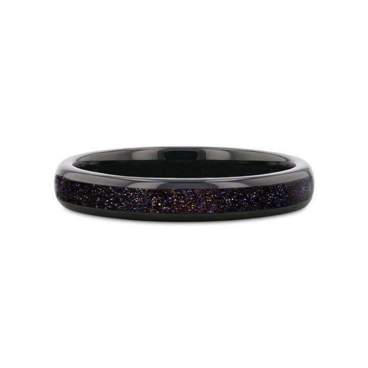 Flat lay of ASTRUM black tungsten ring highlighting the crushed blue and purple goldstone inlay, 4mm