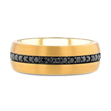 Gold-plated tungsten carbide ring laid flat, displaying the continuous center channel set with black sapphires