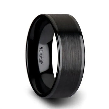 Angled view highlighting the brushed matte center band and polished edges on a black ceramic ring