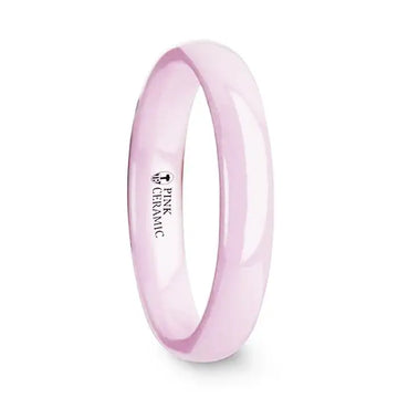 Side view of a polished pink ceramic domed wedding band, 4mm width, with interior marking that reads Pink Ceramic.