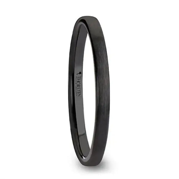 Black flat 2 mm ceramic wedding band with brushed finish shown at an angle on white background