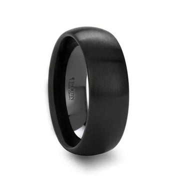 Angled view of a black domed brushed-finish ceramic wedding band