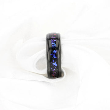 Lifestyle image of COSMIC black tungsten ring with crushed Alexandrite and goldstone inlay