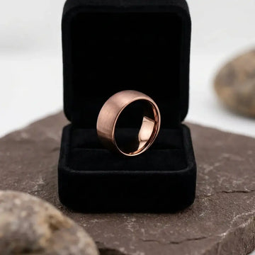 Domed rose gold tungsten band with brushed finish displayed in black velvet ring box.