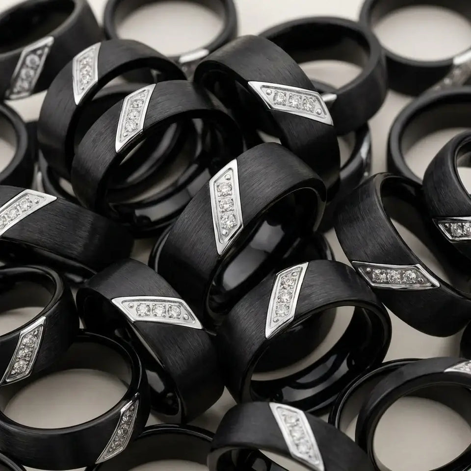 Black satin tungsten carbide wedding bands with diagonal silver diamond inlays displayed in rows.