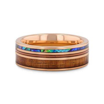 Flat lay highlighting the polished smoked rose gold edges with koa wood and abalone inlays on the 8mm tungsten ring