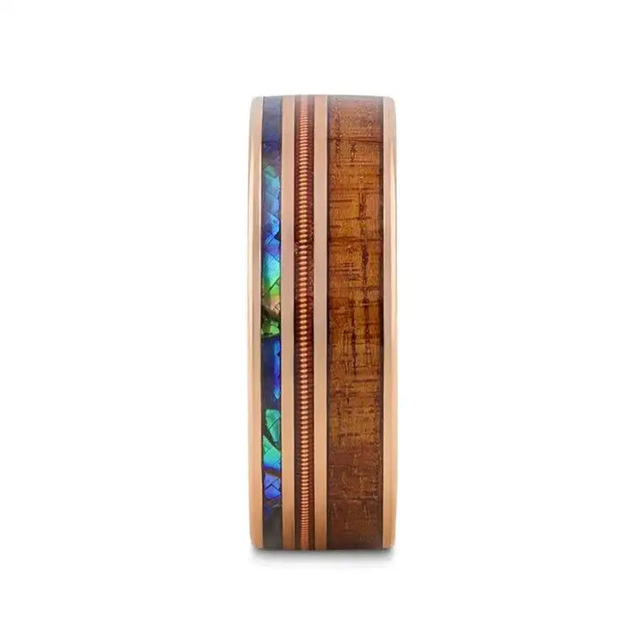 Front view showing the parallel inlays of koa wood, copper guitar‑string, and iridescent abalone on the smoked rose gold tungsten band