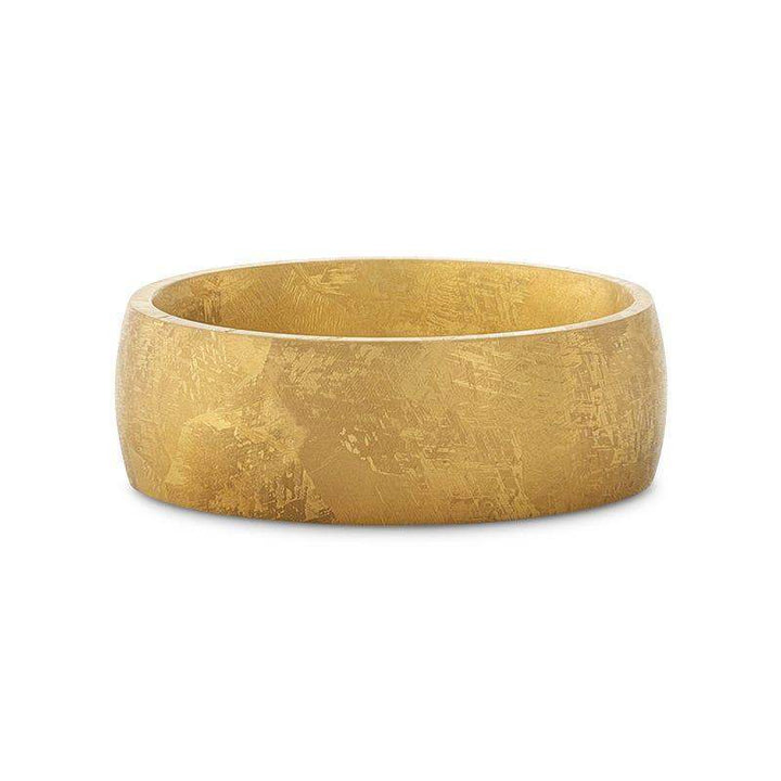Domed gold-plated titanium ring with meteorite pattern, flat laid side view