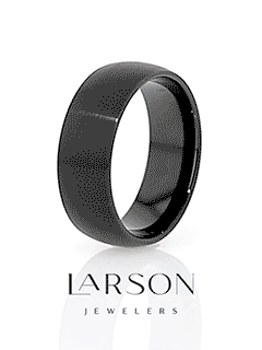 Lifestyle shot: black tungsten domed brushed ring displayed in a cream-lined wooden ring box