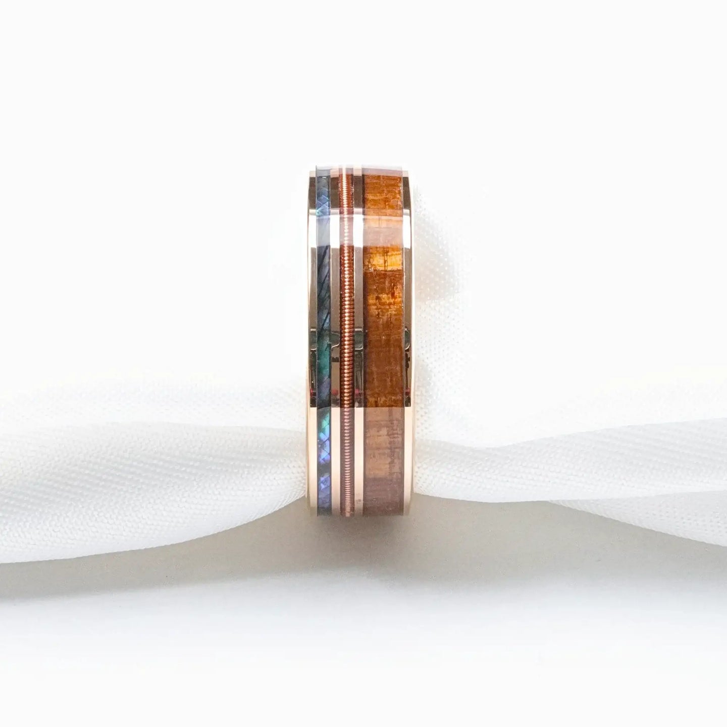 Studio shot, vertical orientation, displaying the triple inlay design on the smoked rose gold tungsten ring