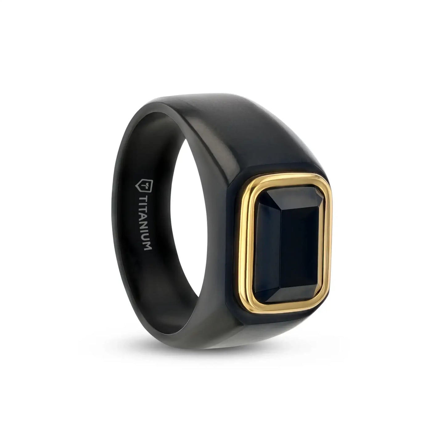 Angled view of a black titanium signet ring featuring a rectangular black onyx inlay framed with gold plating