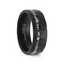 Angled side view of a black tungsten carbide ring with a faceted hammered texture and an offset crushed meteorite inlay, 8mm width