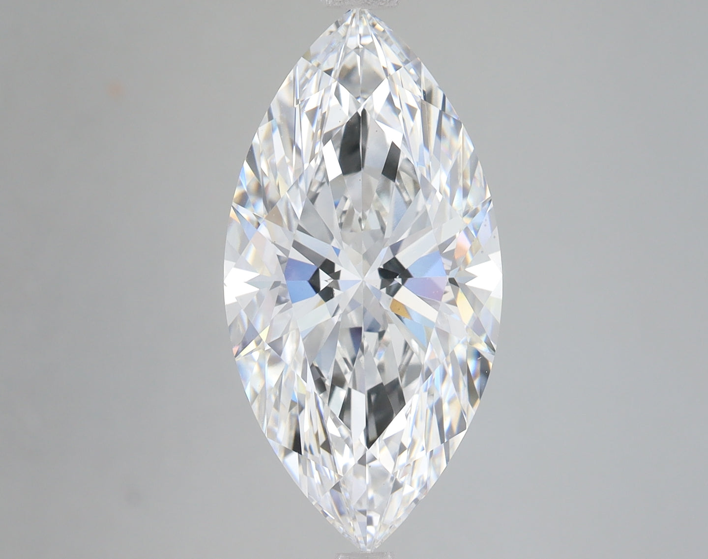 Marquise-cut colorless diamond with faceted surface and light refraction displayed against neutral gray background.