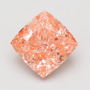 Cushion-cut loose diamond with peachy-pink hue and faceted surface, displayed against neutral background.