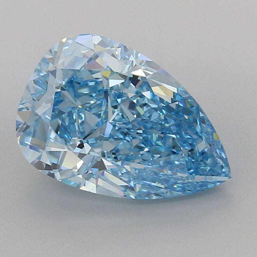 Pear-shaped lab-grown diamond with faceted surface displaying blue and clear tones on neutral background.